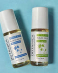 Two Botanica CBD body oil roll-on bottles on a blue background, featuring intense and extreme relief formulas