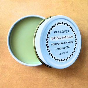 Open tin of CBD topical ear balm for pets labeled for pain and panic relief